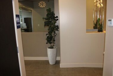 Walking into a dentist office with bathroom and hallway to front desk.