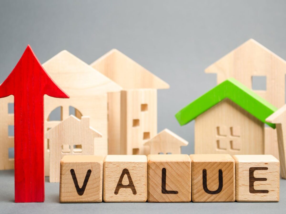 Block houses with a red arrow pointing up and the word value.